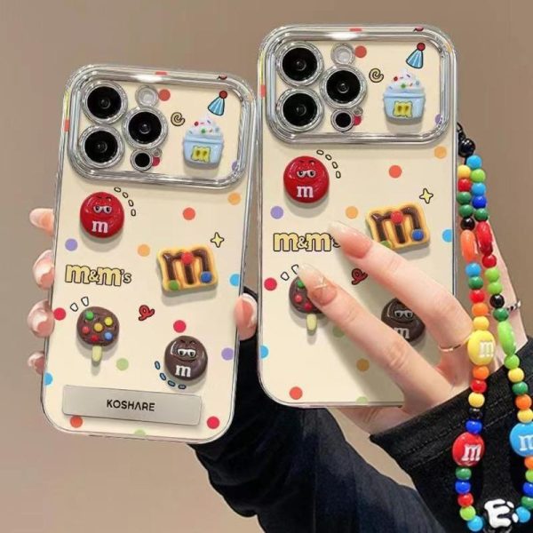 Sarung Telefon Elektropating M & M, Reka Bentuk 3D Comel DIY, dengan Pemegang dan Lanyard, Serasi dengan iPhone 11, 16, 15, 14, 13, 12, Pro, Xs Max, XR, X, 7, 8, 6, 6s Plus, Ins Korea, Sarung Telefon TPU Lembut, Penutup Belakang Pelindung Kalis Kejutan